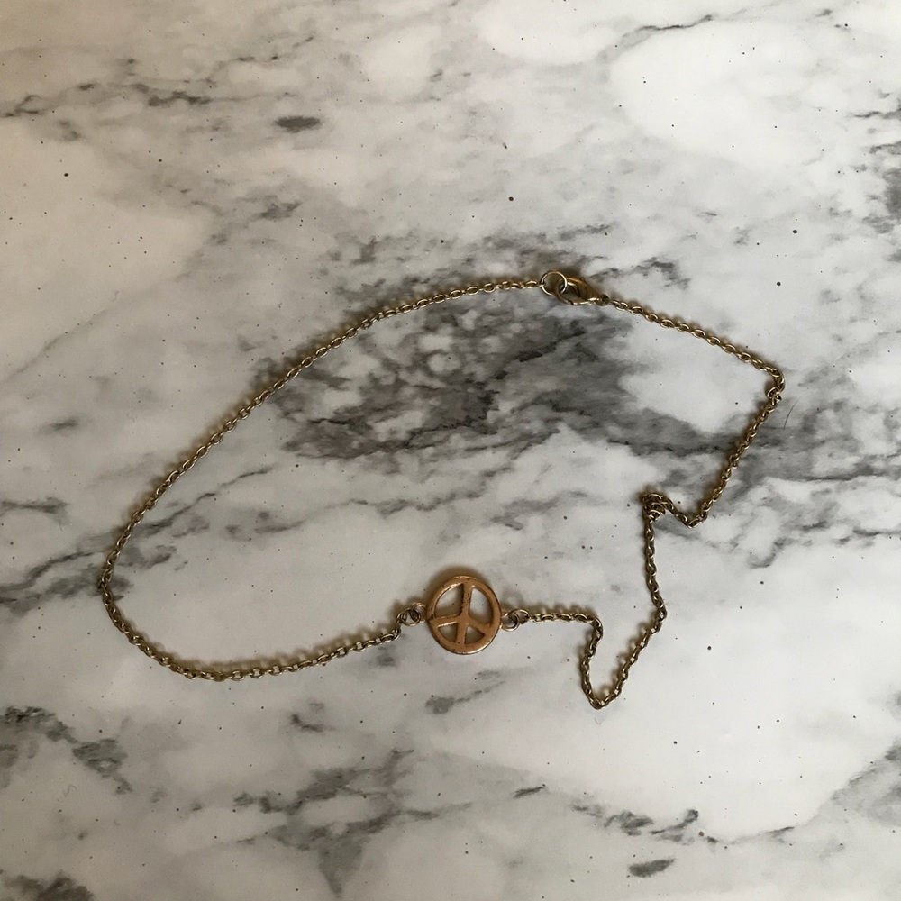 Delicate gold peace sign necklace